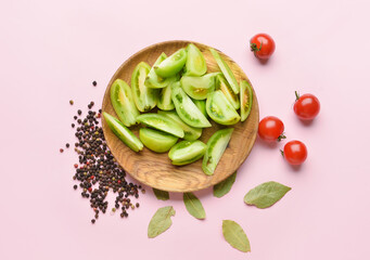 Plate with ingredients for preparing canned tomatoes on color background