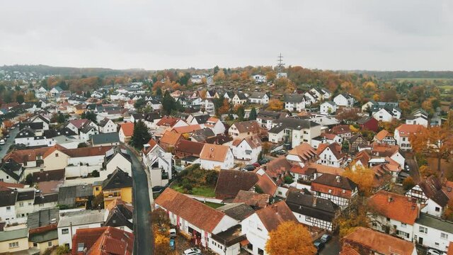Aerial flyover residential houses with red tile roofs in small suburban town, Dietzenbach, Germany, Europe, cinematic 4K