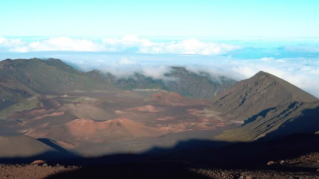 Aerial wide shot of beautiful Volcano Landscape with flying clouds and blue sky - Crater Scenery of Haleakala Maui, Hawaii