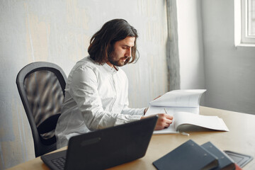 Stylish young businessman working with documents