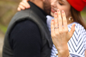 Beautiful engaged couple in autumn park, closeup