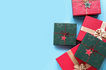 Beautifully decorated Christmas gift boxes on color background