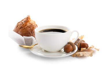 Cup of coffee with acorns and tasty cupcake on white background