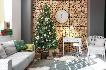 Interior of living room with beautiful Christmas tree and modern workplace