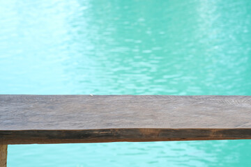 wooden table top on the blue water as background or montage