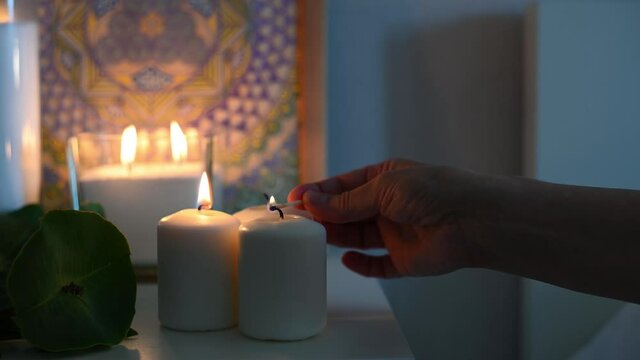 man lights white candles for isoteric ritual. High quality 4k footage