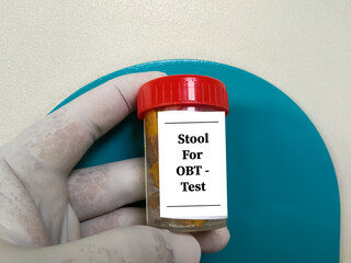 Fecal occult blood test (FOBT). Doctor holding sample container with feces or stool for occult...