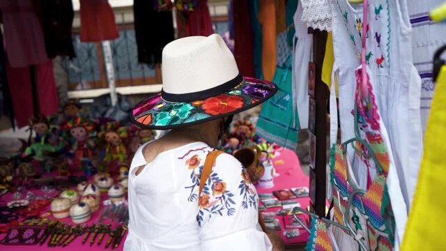 Woman is chooses souvenirs at a street market
