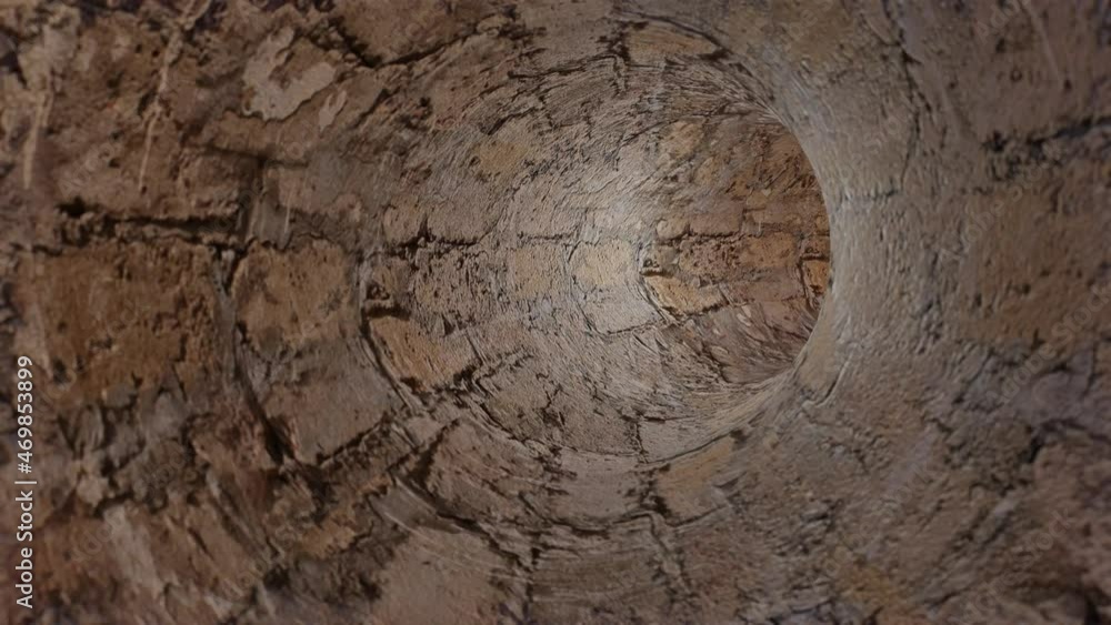 Poster camera flight through a round tunnel made of old concrete blocks. looped animation. 3d render