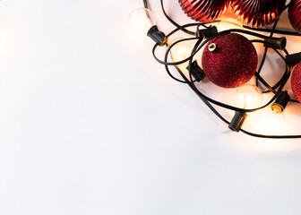 Set of Christmas spheres with lights on white background with space for text.