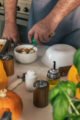 Staying at home and cooking. Homemade Italian pumpkin ricotta ravioli. Men making pumpkin ricotta filling for ravioli.