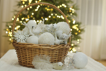 White Christmas ornaments in wicker basket. Preparation for Christmas. Selective focus.  