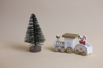 toy locomotive and a carriage isolated going to christmas tree on gray background