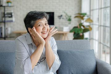 Fototapeta na wymiar Mature Asian woman gesturing thumb up
