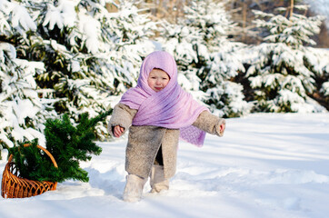 Little girl having fun at winter day on the big snow. Outdoor fun for family Christmas vacation. Winter activities for kids. Cute toddler enjoying a day out playing in the winter forest