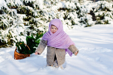 Fototapeta na wymiar Little girl having fun at winter day on the big snow. Outdoor fun for family Christmas vacation. Winter activities for kids. Cute toddler enjoying a day out playing in the winter forest