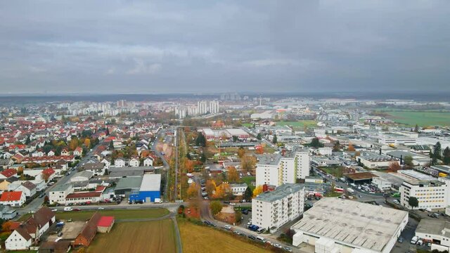 Aerial, agricultural suburb with high rise apartment buildings in Europe, Dietzenbach Germany. Overcast day