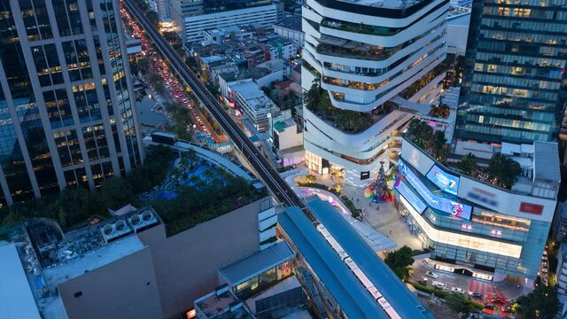 aerial view of ฺPhrom Phongintersection or junction with cars traffic skyscraper buildings. Bangkok City in downtown at night, Thailand. 