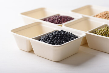 Black soybeans in compostable cardboard boxes are eco-friendly concepts and are mainly used as a plant-based ingredient in vegetarian, healthy food.