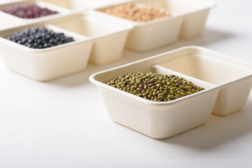 Mungbeans in compostable cardboard boxes are eco-friendly concepts and are mainly used as a plant-based ingredient in vegetarian, healthy food.