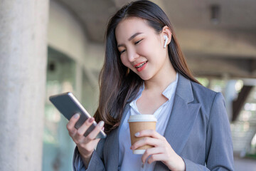 Working woman concept a young female manager holding a cup of coffee and communicating with the colleague via the video call