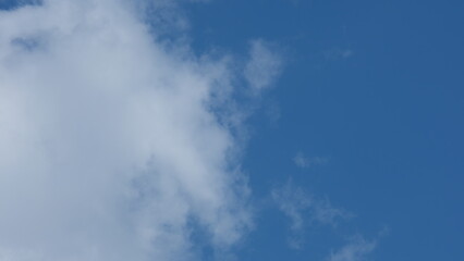 View of beautiful blue sky background with white clouds at the noon, Bangkok, Thailand.