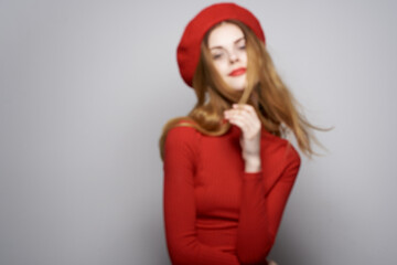 cheerful woman with a red cap on his head glamor light background