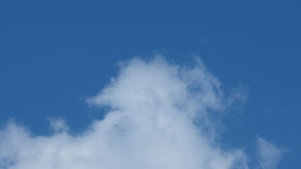 View of beautiful blue sky background with white clouds at the noon, Bangkok, Thailand.