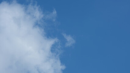 View of beautiful blue sky background with white clouds at the noon, Bangkok, Thailand.