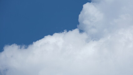 View of beautiful blue sky background with white clouds at the noon, Bangkok, Thailand.