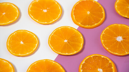 orange fruit on pink and white background