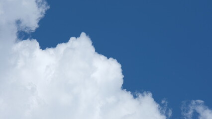 View of beautiful blue sky background with white clouds at the noon, Bangkok, Thailand.