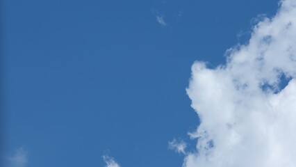 View of beautiful blue sky background with white clouds at the noon, Bangkok, Thailand.