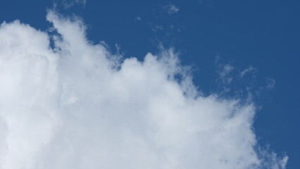 Fototapeta premium View of beautiful blue sky background with white clouds at the noon, Bangkok, Thailand.