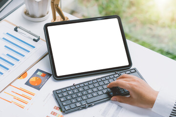 professional business woman working at her office via digital tablet with blank screen in office