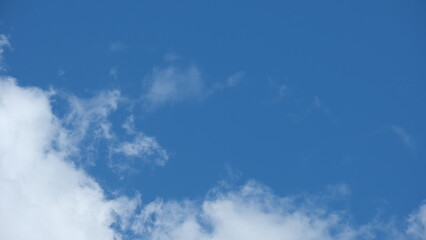 View of beautiful blue sky background with white clouds at the noon, Bangkok, Thailand.