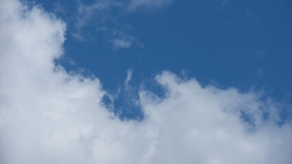 View of beautiful blue sky background with white clouds at the noon, Bangkok, Thailand.