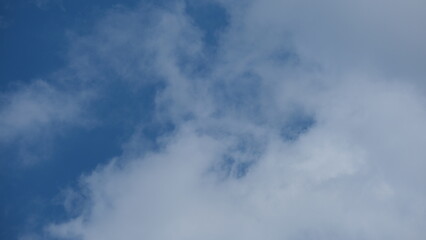 View of beautiful blue sky background with white clouds at the noon, Bangkok, Thailand.