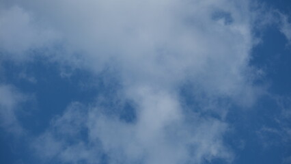 View of beautiful blue sky background with white clouds at the noon, Bangkok, Thailand.