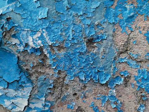 Blue Background With Cracked Oil Paint On Plaster.