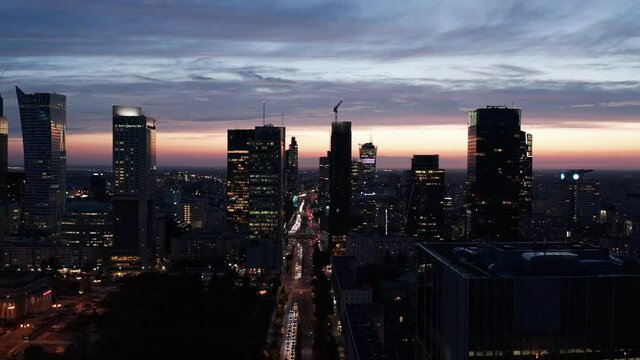 Amazing panoramic shot of downtown skyscrapers against picturesque twilight sky. Silhouettes of modern high rise office buildings. Warsaw, Poland