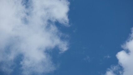 View of beautiful blue sky background with white clouds at the noon, Bangkok, Thailand.