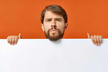 emotional man holding a white banner design orange background