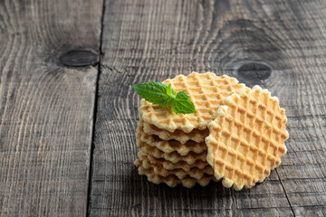 Round Belgian waffles on rustic wooden table