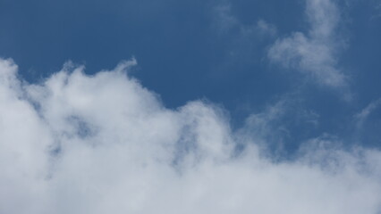 View of beautiful blue sky background with white clouds at the noon, Bangkok, Thailand.