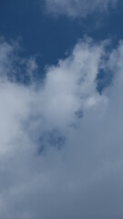 View of beautiful blue sky background with white clouds at the noon, Bangkok, Thailand.