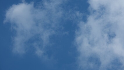 View of beautiful blue sky background with white clouds at the noon, Bangkok, Thailand.