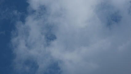 View of beautiful blue sky background with white clouds at the noon, Bangkok, Thailand.