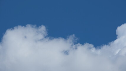 View of beautiful blue sky background with white clouds at the noon, Bangkok, Thailand.