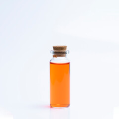 Orange liquid bottle on white background